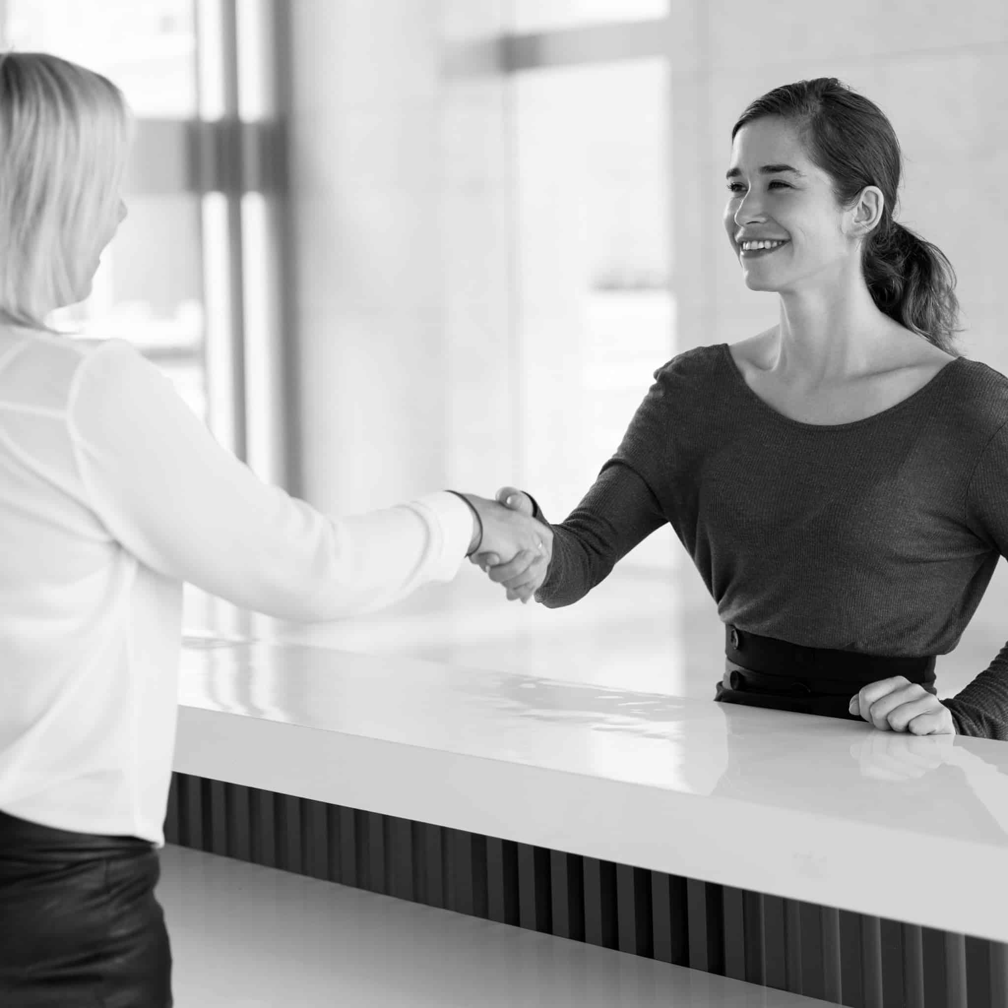 Office receptionist greeting corporate partner